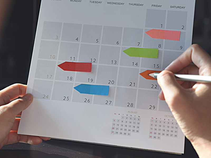 Person using a calendar, to make plans.