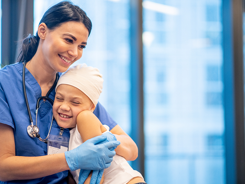 A female clinician embraces a younger patient
